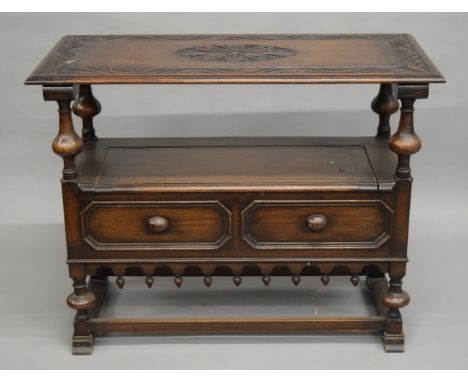 An early 20th century carved oak monk's bench. 107 cm wide.