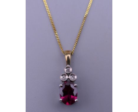 A 9 ct gold ruby and diamond pendant on a 9 ct gold chain. The pendant 1.75 cm high. 2.9 grammes total weight.