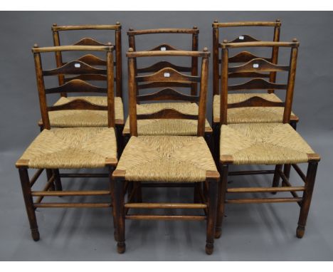 A set of six 19th century ash rush seated ladder back chairs. 46 cm wide.