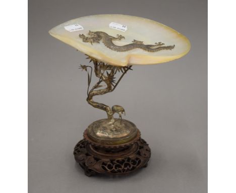 A Chinese silver and mother-of-pearl set tazza mounted on a carved wooden plinth base. 22 cm high.