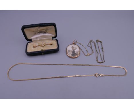 An unmarked gold and seed pearl brooch (1.6 grammes total weight), a 9 ct gold necklace (3.6 grammes) and a 9 ct gold framed 