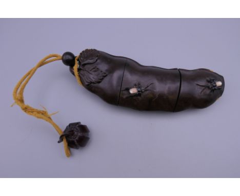 A Japanese wooden mother-of-pearl inset inro carved with insects. 17.5 cm long.