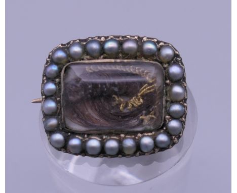 A 19th century natural seed pearl mounted mourning brooch. 1.5 cm wide.