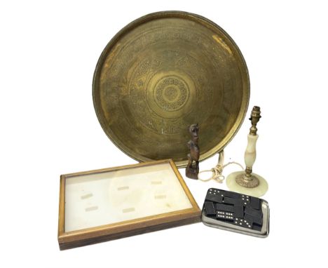 Engraved brass charger, D57cm, together with glazed oak display case, onyx table lamp, carved wood figure etc