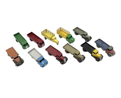 Dinky - eleven unboxed and playworn/repainted early die-cast commercial vehicles including flatbed and planked flatbed lorrie