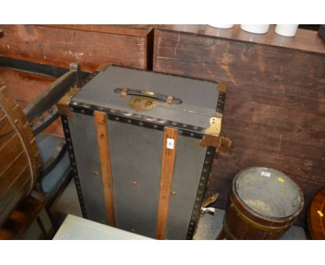 A wooden and metal bound travelling trunk