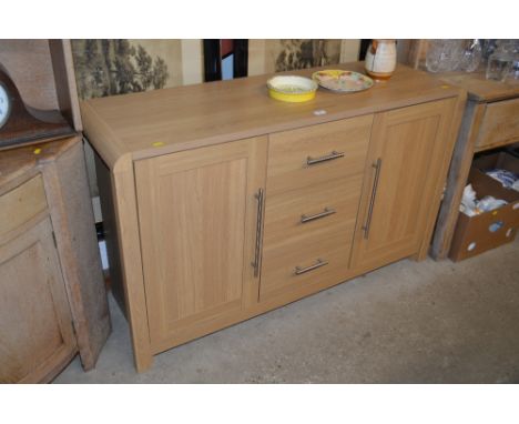 A modern light oak veneered sideboard fitted three drawers 