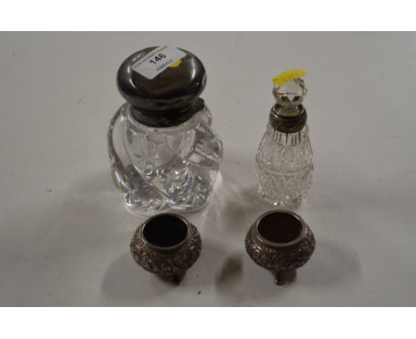 A large silver topped and glass inkwell together with a silver necked scent bottle; and two Eastern white salts 