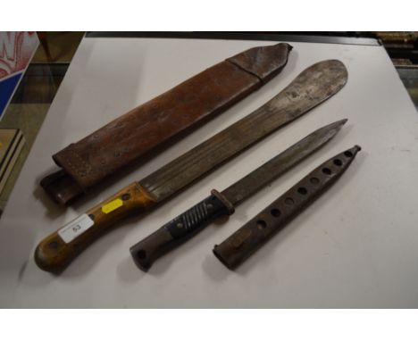 A German bayonet; and a British machete 