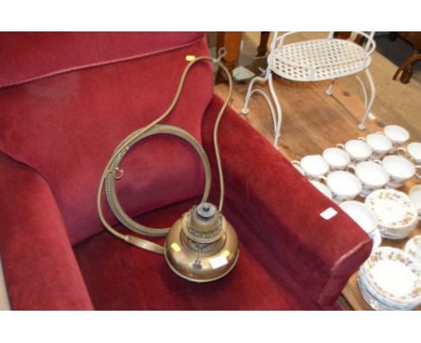A brass hanging oil lamp (lacking shade)