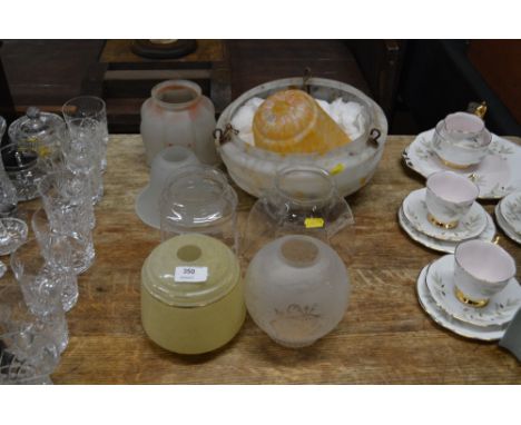 A collection of various glass light shades 