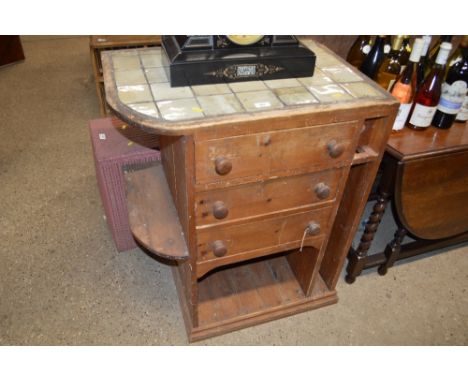 A pine and tile topped three drawer chest 