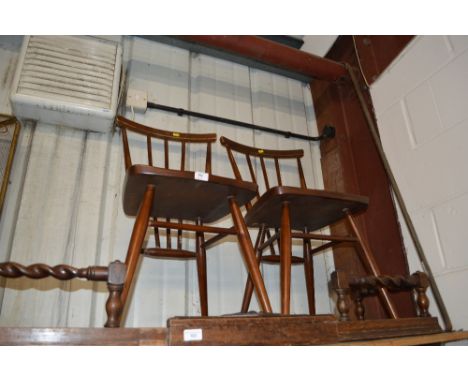 A pair of Ercol stick back chairs 