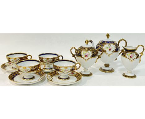 A Japanese Noritake fine porcelain tea or coffee set with blue and gilt decoration and enamelled floral sprays comprising a t