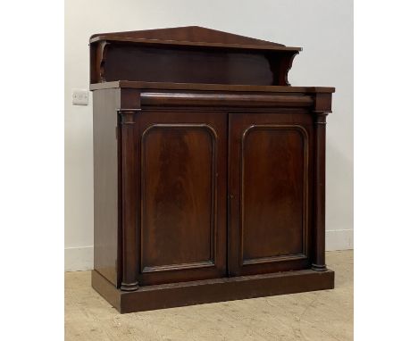 A mid 19th century mahogany side cabinet / chiffonier, the arched raised back with open shelf above frieze drawer and two pan