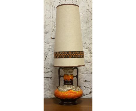 A large West-German fat lava glazed lamp base, of ribbed cylinder and ovoid form, with twin handles and complete with origina