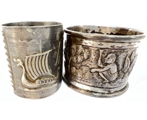 An Indian white metal repousse napkin ring decorated with figural scenes (vacant cartouche), together with a European white m