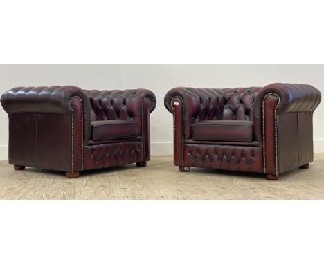 A pair of Vintage chesterfield club chairs, upholstered in deep buttoned oxblood leather. H70cm, W102cm, D90cm.&nbsp;