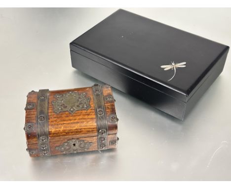 A modern black lacquered jewellery box of rectangular shape the hinged cover with white enamel dragonfly enclosing&nbsp; a se