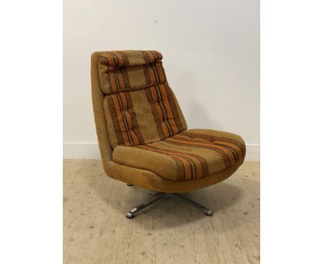 A 1970's upholstered lounge chair, swivelling on a four point chrome base. H92cm.&nbsp;