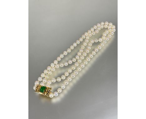 A good white Akoya cultured two strand pearl choker necklace with 14ct gold clip fastening set with two vivid green bars of J
