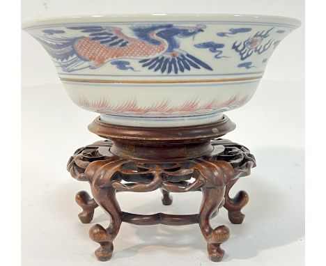 A Chinese porcelain bowl decorated with phoenix and dragon in underglaze red and cobalt blue (apocryphal six character Kangxi