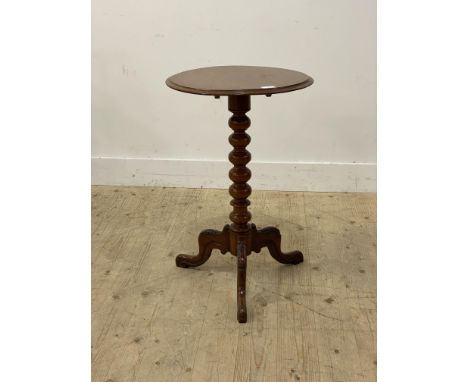 A Victorian walnut wine table, the circular tilt top raised on a bobbin turned column and three floral carved splayed support