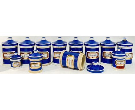 A collection of Victorian ceramic blue apothecary jars with verre eglomise gilt labels (some cracks/losses, largest h- 18cm, 