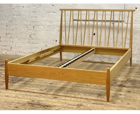 Ercol, a 'Shalstone' light oak contemporary bed frame, standard double, with spindle headboard and raised on turned supports,