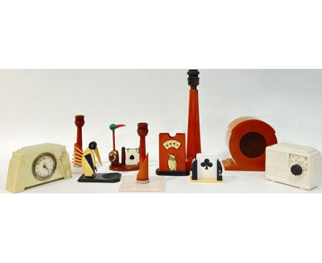 A quantity of bakelite/early plastic objects comprising two bridge trump suit indicators, a deck holder with owl, a match hol