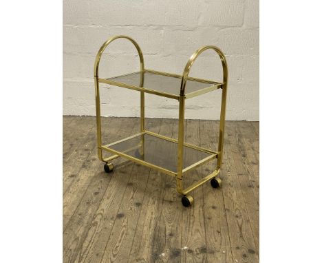 A Vintage 1980's two tier gilt metal and smoked glass drinks trolley, moving on castors. H85cm, L67cm.&nbsp;