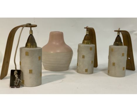 A set of three mid century Danish wall sconces, teak brackets with opaque glass shades of ribbed cylindrical form, together w