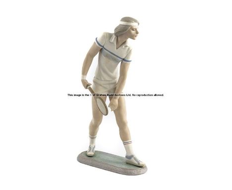 Lladro Tennis Player porcelain figurine,
designed by Juan Huerta, circa 1982 modelled standing about to serve on an oval base