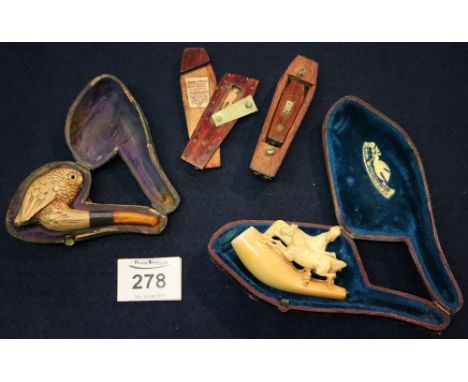 Two cased Meerschaum smoking pipes and a novelty coffin shaped wooden snuff box with inscription 'You're a tricky chap, take 