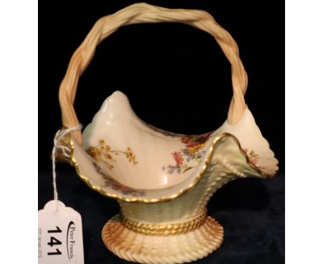 Royal Worcester porcelain peach ground basket shaped posie vase with cane work handle and painted flower spray decoration. Pr