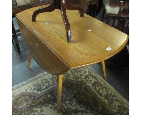 Light elm Ercol drop leaf table on square tapering legs. (B.P. 24% incl. VAT)