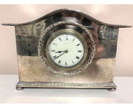 A French silver plated mantel clock on bun feet, retailed by Liberty &amp; Co. London