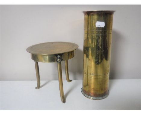 A brass trench art trivet together with a brass ammunition shell