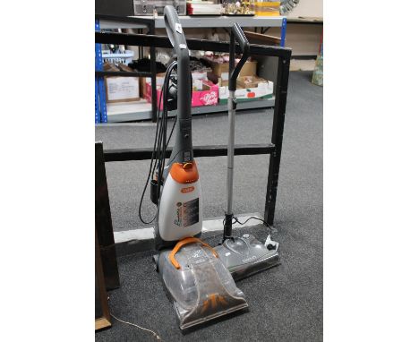 An upright Vax rapide carpet cleaner together with a G-tech cordless carpet sweeper 