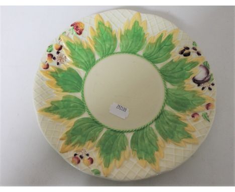 A Clarice Cliff Newport pottery plate with leaf and fruit design 