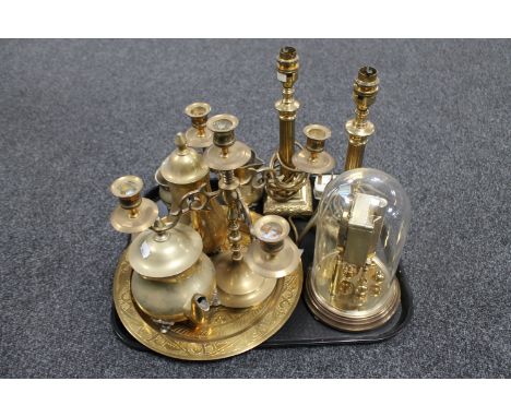 A tray of assorted brass ware including a pair of brass column table lamps, four-way table candelabra, four piece tea service
