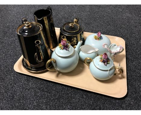 A tray containing a four piece black and gilt Victorian pottery tea service, Crown Staffordshire teapot, milk jug and sugar b