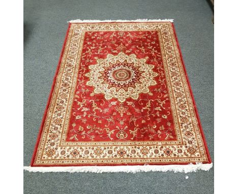 A Keshan carpet on red ground 230 cm x 150 cm