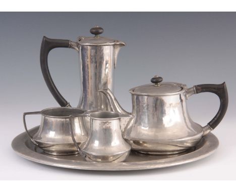 A 1920's LIBERTY &amp; CO. TUDRIC HAMMERED PEWTER TEA SERVICE having tea and coffee pot, cream and sugar on a circular tray 3