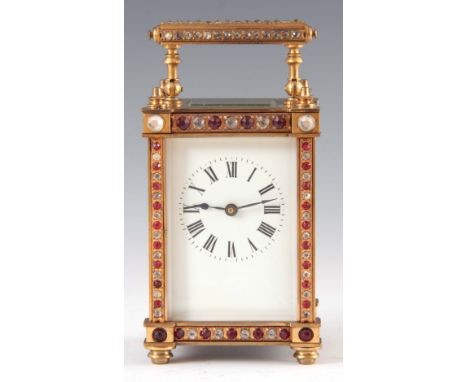 AN EARLY 20th CENTURY FRENCH CARRIAGE CLOCK the brass case with faux diamond and ruby decoration enclosing a 5.5cm porcelain 