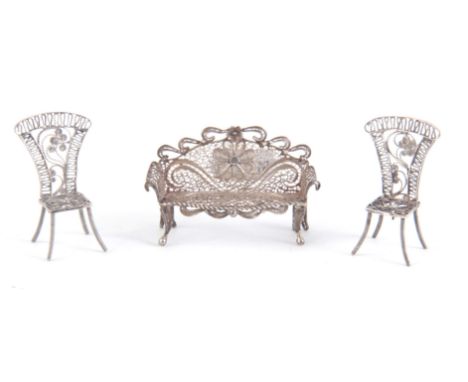 A COLLECTION OF EIGHT PIECES OF MINIATURE SILVER METAL FURNITURE all with fine filigree work comprising of two tables, two so