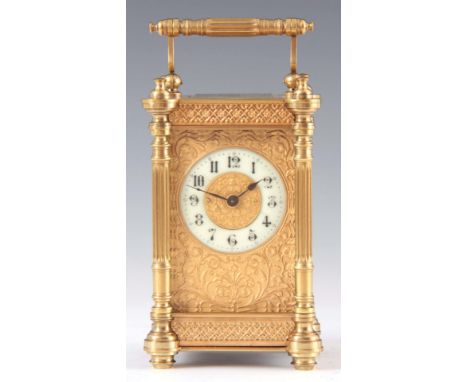 AN EARLY 20th CENTURY FRENCH CARRIAGE CLOCK the brass case with reeded columns enclosing a 5.5cm gilt embossed masked dial wi