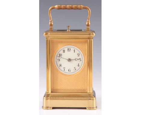 A LATE 19th CENTURY FRENCH REPEATING CARRIAGE CLOCK the decorative moulded brass case enclosing a 6cm gilt engine turned mask
