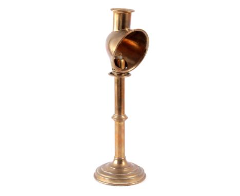 A LATE 19th CENTURY BRASS STUDENT CANDLESTICK  with a circular base 40cm high