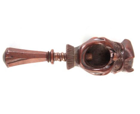 A 19TH CENTURY GROTESQUE TWO FACED TREEN NUTCRACKER fruitwood screw action handle cracks the nut in his open mouth 15cm high 
